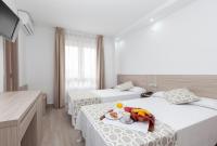 Posteľ alebo postele v izbe v ubytovaní Hotel Olympia Ronda II