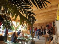 a group of people sitting at tables in a restaurant at Chrom Ranch Reiterhof in Memmingen