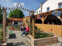 a group of people sitting in a garden at Chrom Ranch Reiterhof in Memmingen