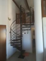 a spiral staircase in a room with a hallway at residence Mare Turchinu in Monticello
