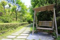 a wooden bench sitting on a path in a park at Yun Wu B&amp;B in Ren&#39;ai