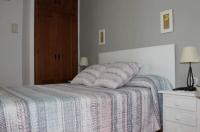 a bedroom with a bed with a blue and white blanket at Hostal El Espinel in Zahara de los Atunes
