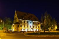 a large building with lights on the side of it at night at Ringhotel Jägerhof in Weißenfels