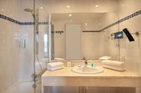 a bathroom with a sink and a shower at Hôtel et Résidence de Chiberta et du Golf in Anglet