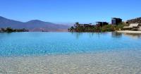 a large body of water with mountains in the background at Encuentro Guadalupe in Valle de Guadalupe