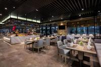 a restaurant with tables and chairs and a buffet at Wyndham Grand Maoming in Maoming