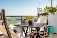 a table and chairs on a balcony with a view at Hotel Boutique V in Vejer de la Frontera