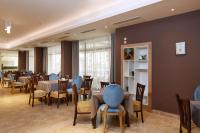 een eetkamer met tafels en blauwe stoelen bij Hotel Nobel Ultra All Inclusive - FREE Beach Access in Sunny Beach