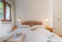 Posteľ alebo postele v izbe v ubytovaní Apartments Coronata