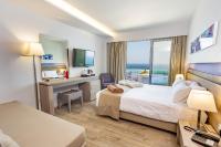 A bed or beds in a room at Akti Imperial Deluxe Resort & Spa Dolce by Wyndham