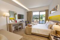 A bed or beds in a room at Akti Imperial Deluxe Resort & Spa Dolce by Wyndham