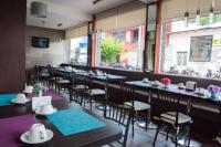a row of tables and chairs in a restaurant at Hotel San Miguel, en el Centro - Desayuno Incluido in Tuxtla Gutiérrez