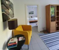 a living room with a yellow chair and a table at Urlaubs(t)raum in Heiligkreuzsteinach