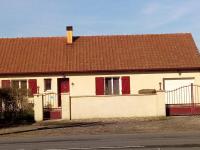 a white house with a brown roof and red doors at les vignes d&#39;Ygrande in Ygrande