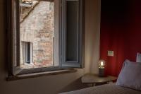 Łóżko lub łóżka w pokoju w obiekcie Santa Cecilia Perugia - Rooms&Suite
