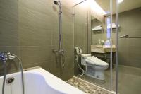 a bathroom with a shower and a toilet and a tub at Pulamayama in Hualien City