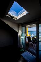 a room with a window and a balcony with the ocean at Summer Ya B&amp;B in Huxi