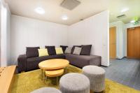 a living room with a couch and a table at Original Sokos Hotel Vaakuna Rovaniemi in Rovaniemi