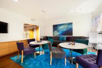 a living room with two tables and a couch at Original Sokos Hotel Vaakuna Rovaniemi in Rovaniemi