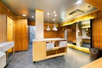 a bathroom with wooden walls and a counter with towels at Original Sokos Hotel Vaakuna Rovaniemi in Rovaniemi