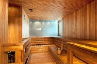 an empty wooden sauna with a bucket in it at Original Sokos Hotel Vaakuna Rovaniemi in Rovaniemi