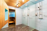 a bathroom with a shower and a walk in shower at Original Sokos Hotel Vaakuna Rovaniemi in Rovaniemi