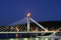 a bridge over the water at night at Original Sokos Hotel Vaakuna Rovaniemi in Rovaniemi