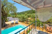 a patio with a swimming pool and a deck with a tree at Neptune in Alonnisos