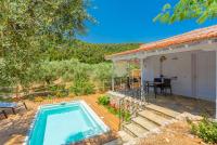 a villa with a swimming pool and a house at Neptune in Alonnisos