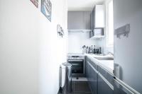 a small kitchen with white cabinets and a sink at Gorgeous Paris Eiffel Tower in Paris