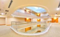 a large room with a glass staircase in a building at HiONE Holiday Hotel in Shenkeng