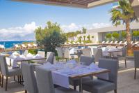 a restaurant with tables and chairs with a view of the ocean at ON'LIVE HOTEL in Cesme