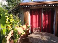 a red shed with a table in front of it at Cazadodo in Étang-Salé