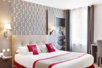 a hotel room with a large bed with red pillows at Best Western Hotel Saint Claude in Péronne