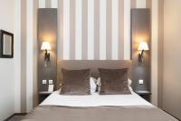 a bedroom with a large bed with two lamps at Best Western Hotel Saint Claude in Péronne