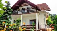 a house with a balcony with flowers on it at Charlie Vendégház,emelet 8 fős,100m2-es apartman in Siófok