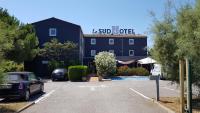 Un edificio con un estacionamiento enfrente. en Contact Hotel LE SUD Montpellier Aéroport Parc Expo Arena, en Mauguio