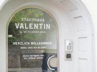 a door with a window with a sign on it at Stadthaus Valentin in Altötting