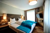 Postel nebo postele na pokoji v ubytování Hotel Dorfstadl
