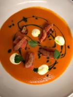 Un plato de comida con camarones y huevos encima. en Residenza Del Lago, en Candia Canavese