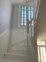 a white staircase with a stained glass window at Relais Vacances à la Mer in Berck-sur-Mer