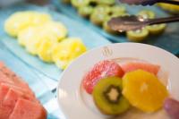 a white plate with fruit on a table at Hotel Jerez &amp; Spa in Jerez de la Frontera