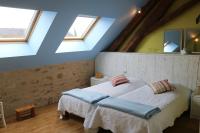 a bedroom with a bed and two windows at Gite Le Meix Chapeau in Levernois