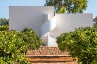 a white house with trees in front of it at Can Jaume by Ocean Drive in Ibiza Town