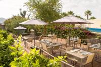 a restaurant with tables and umbrellas next to a pool at Can Jaume by Ocean Drive in Ibiza Town