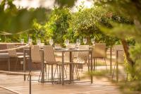 a table with chairs and wine glasses on a deck at Can Jaume by Ocean Drive in Ibiza Town