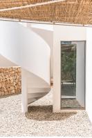 a spiral staircase in a house with a mirror at Can Jaume by Ocean Drive in Ibiza Town