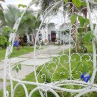 a white wrought iron fence in front of a house at Hasayaki Homestay in Dayi