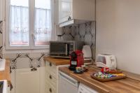 a kitchen with a counter with a toaster and a microwave at Proche Paris, Confort, Wifi, Netflix in Deuil-la-Barre