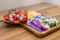 a tray of candy melts and other snacks on a table at Proche Paris, Confort, Wifi, Netflix in Deuil-la-Barre